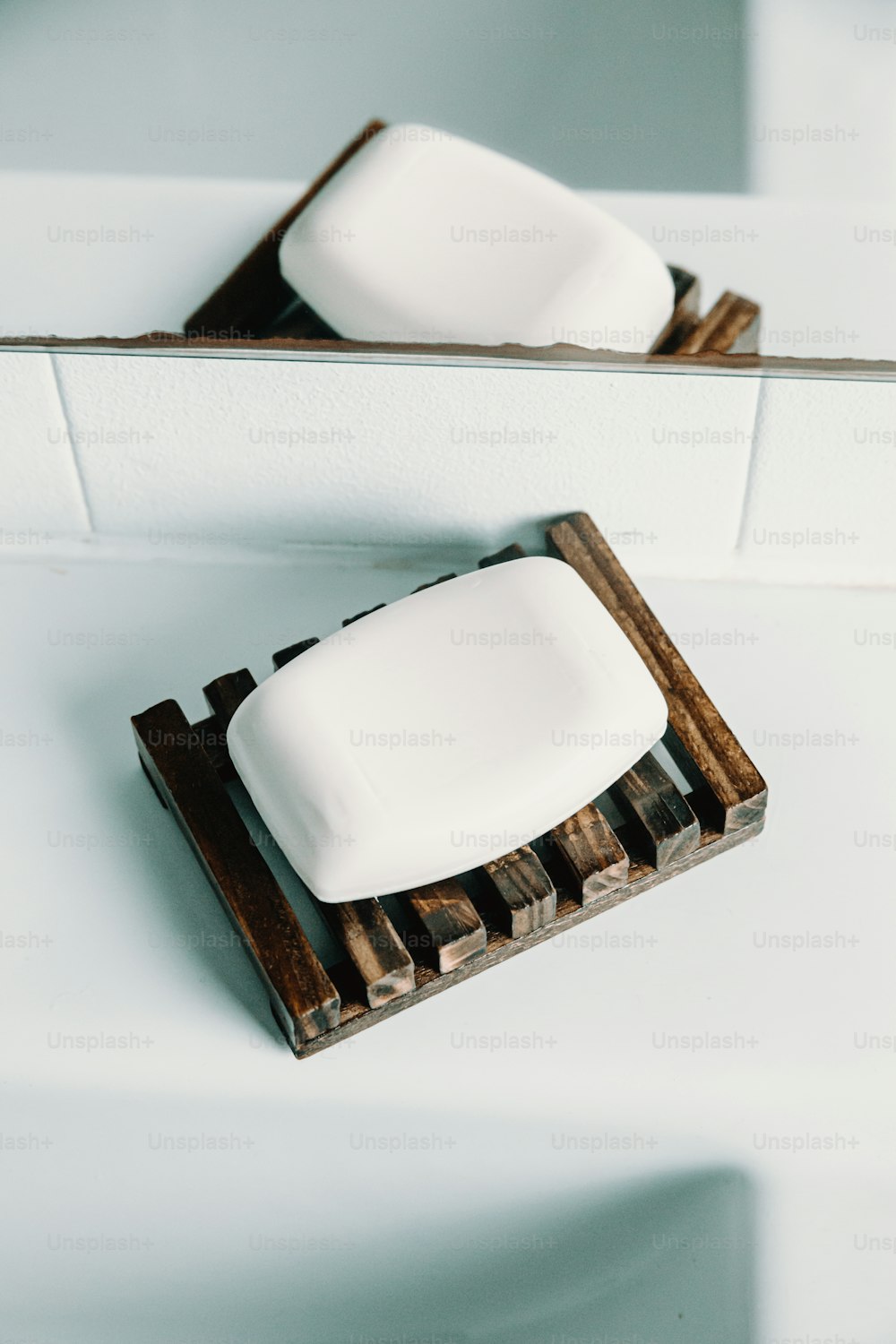 two soap bars sitting on top of a wooden holder
