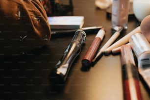 a close up of a table with pens and other items