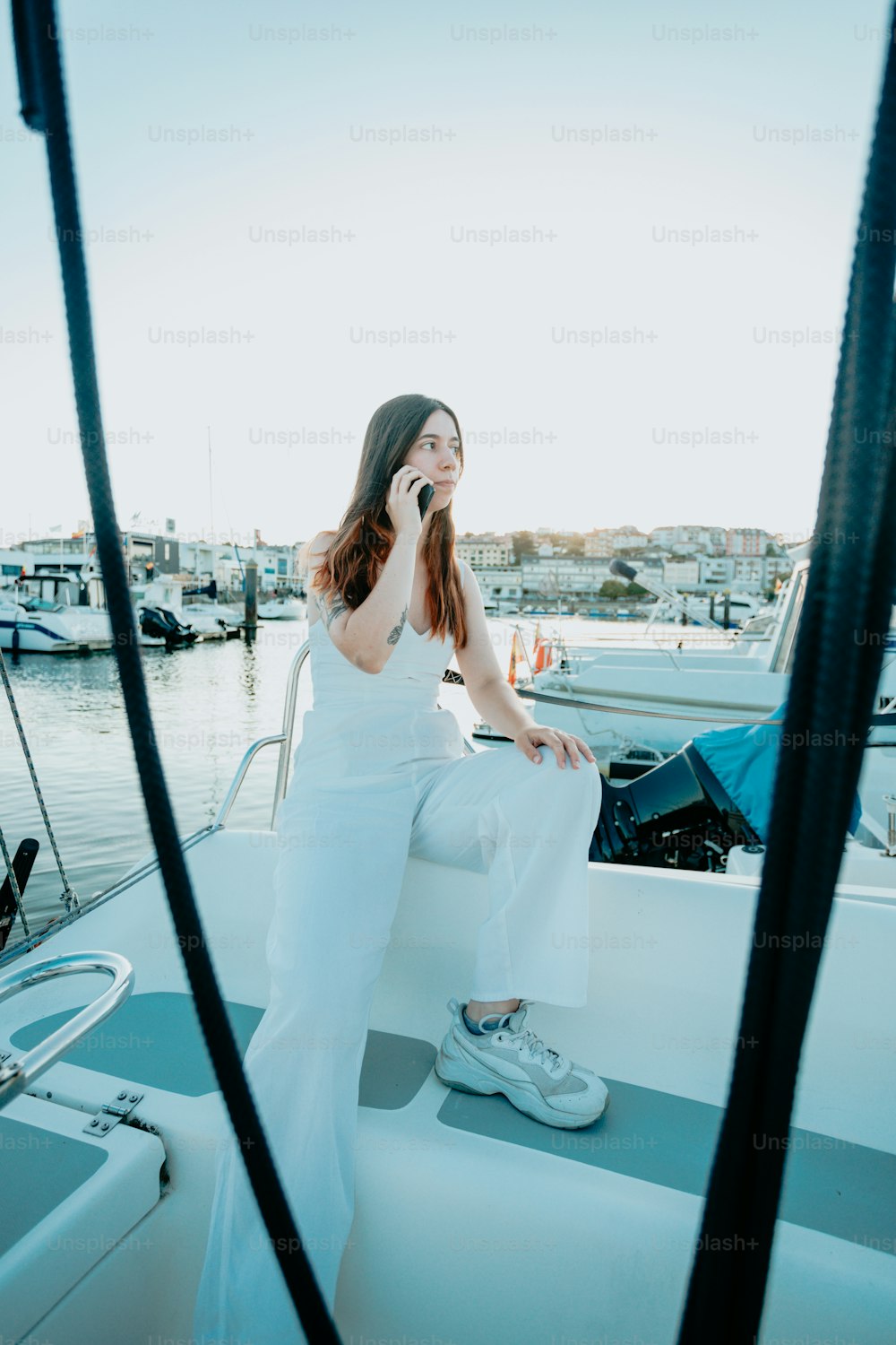 a woman sitting on a boat talking on a cell phone