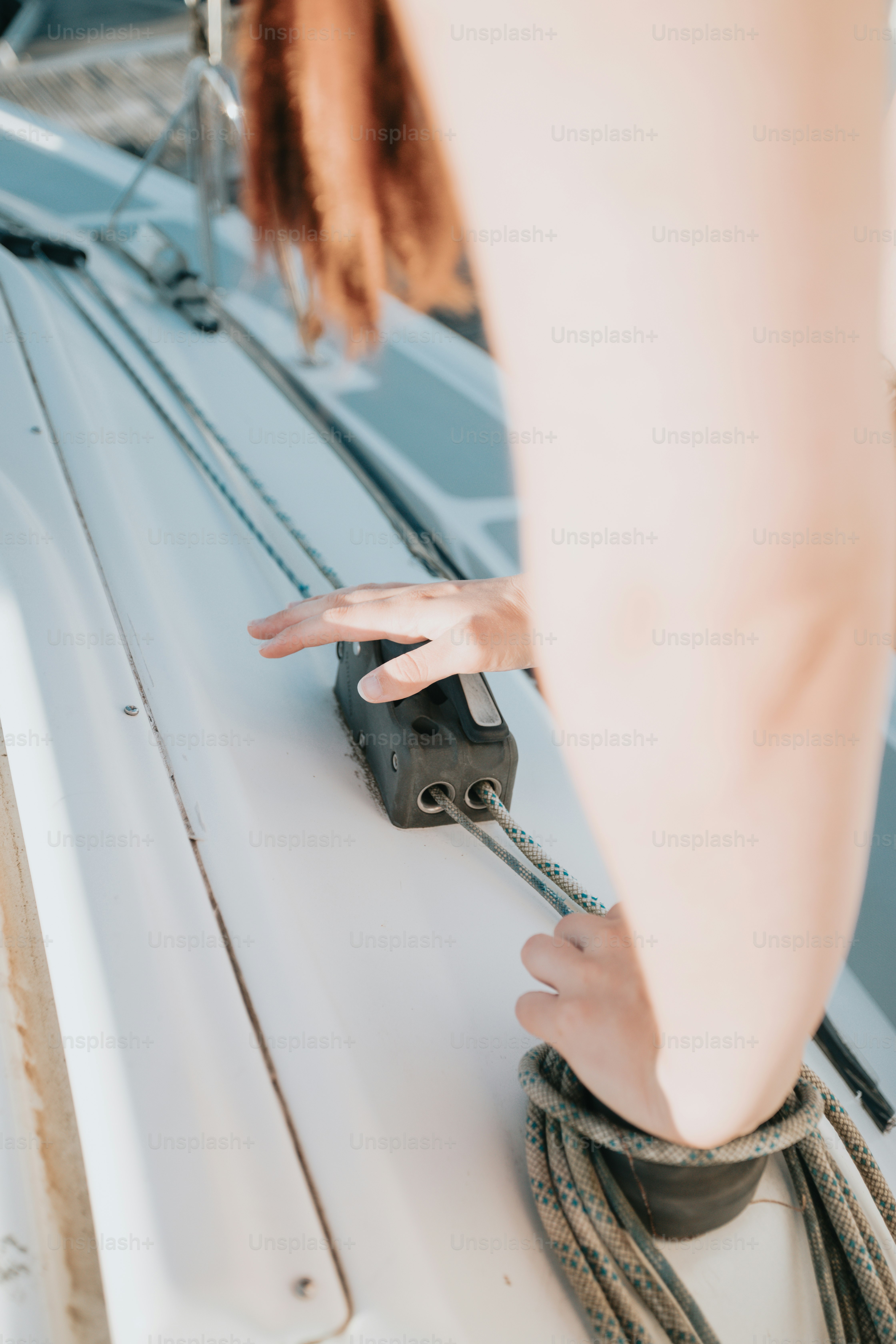 a person holding a rope on top of a boat