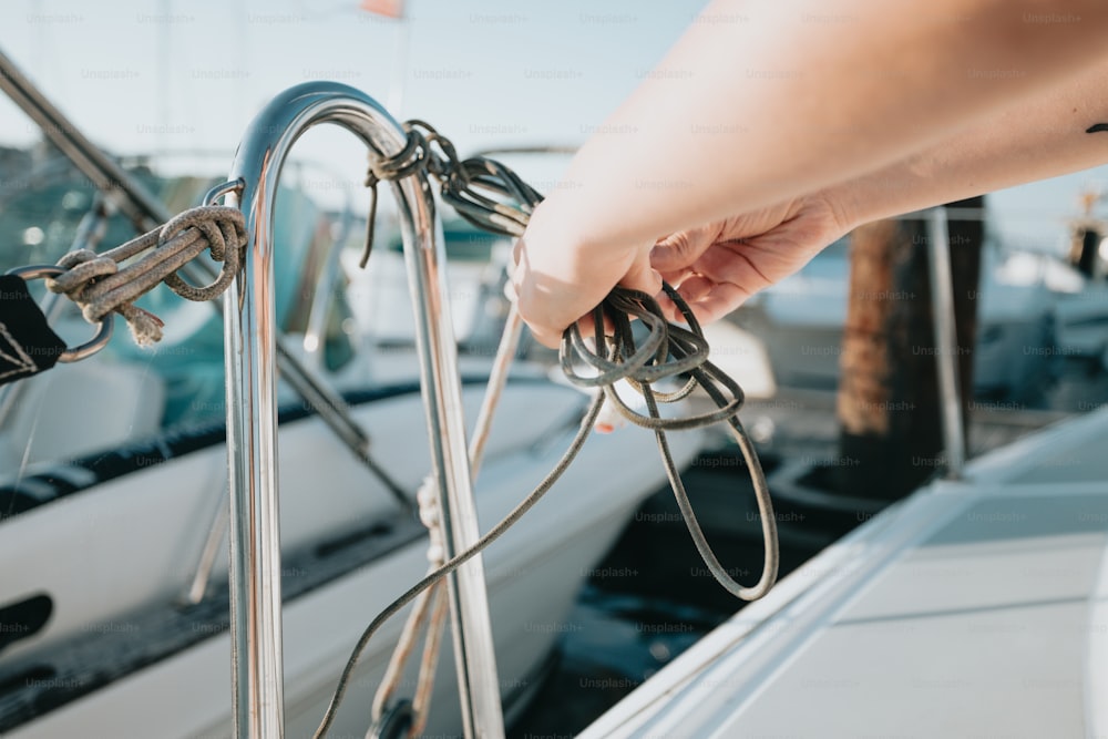 a person is pulling a rope off of a boat