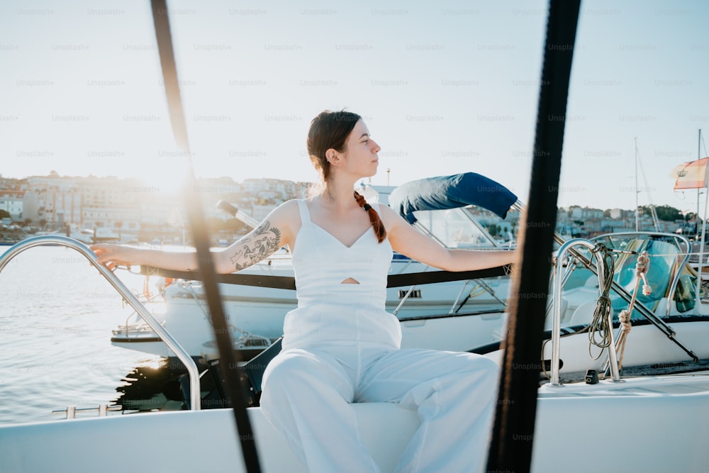 a woman sitting on a boat in the water