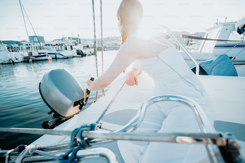 a woman in a white dress sitting on a boat