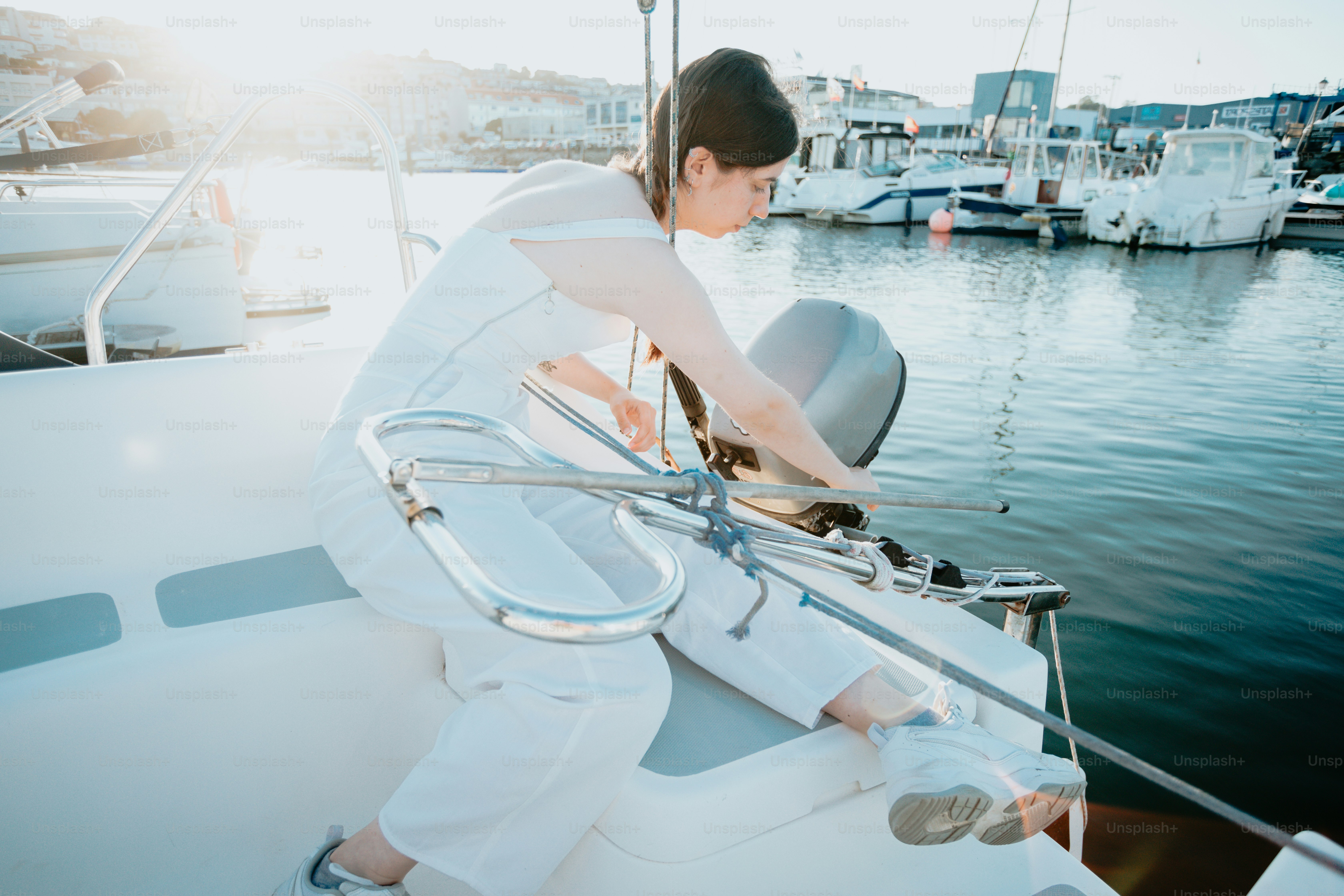 a woman sitting on the bow of a boat