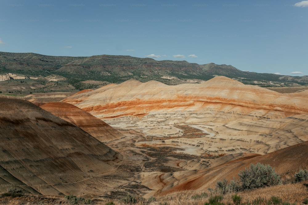 a view of a valley with hills in the background