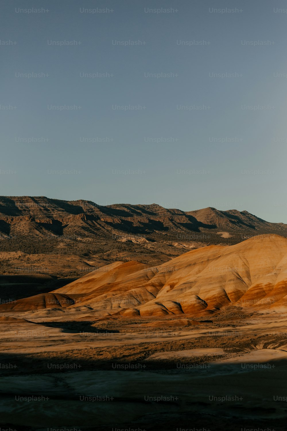 a mountain range with a body of water in the foreground