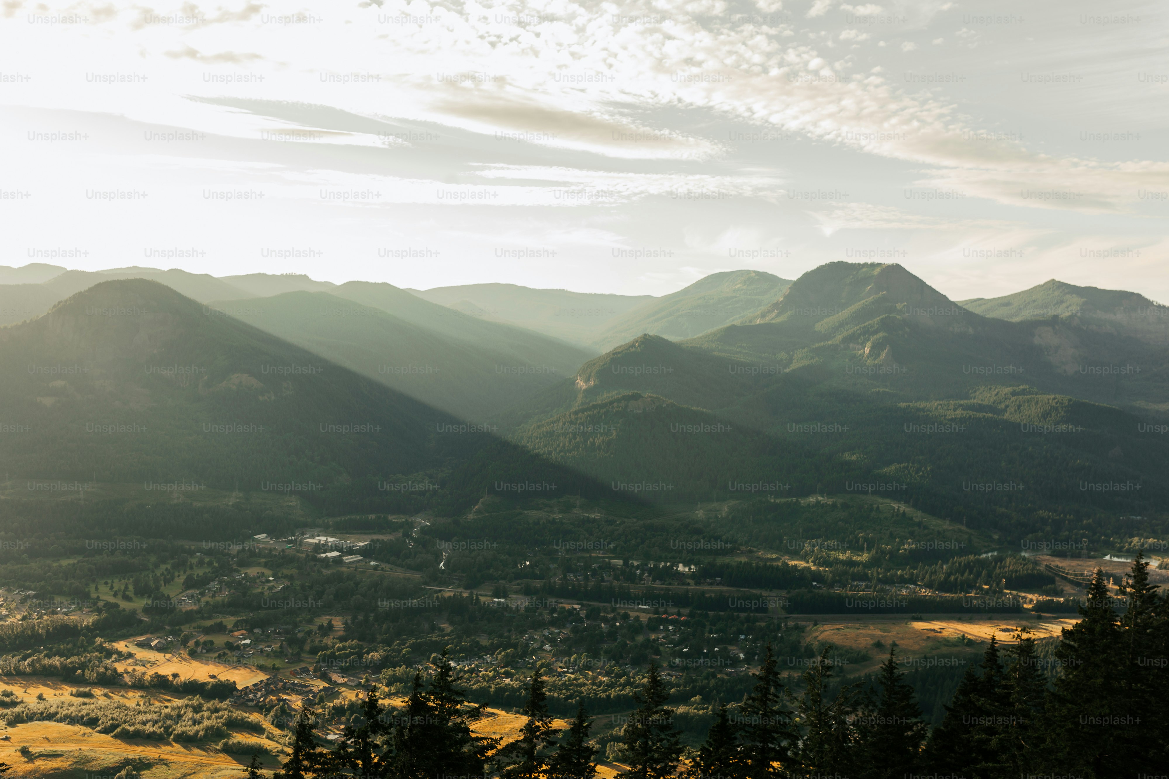 a view of a valley with mountains in the background
