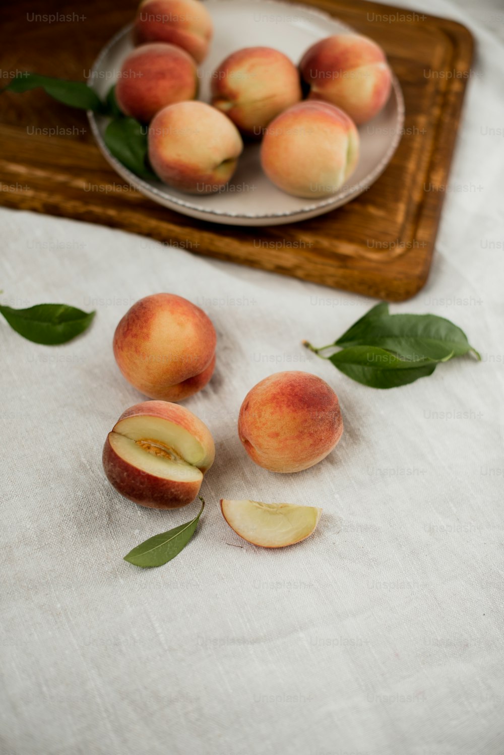 a plate of peaches sitting on a table