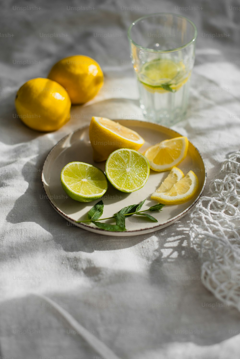 a plate of lemons and a glass of water