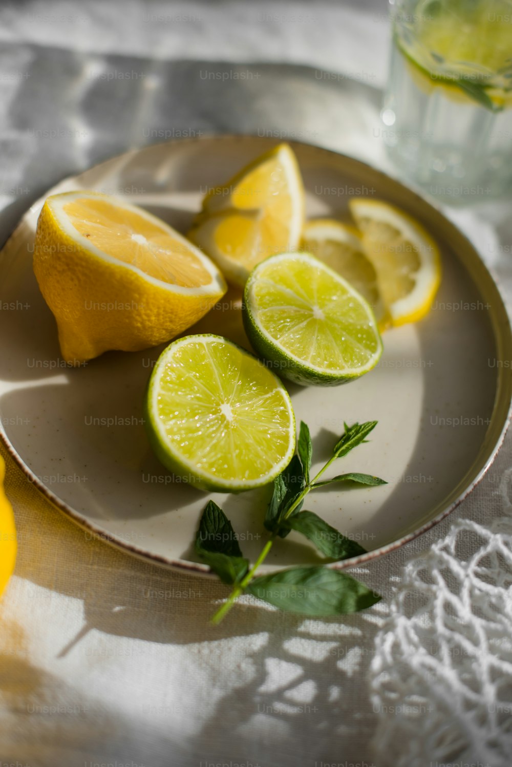 a plate of lemons and limes on a table