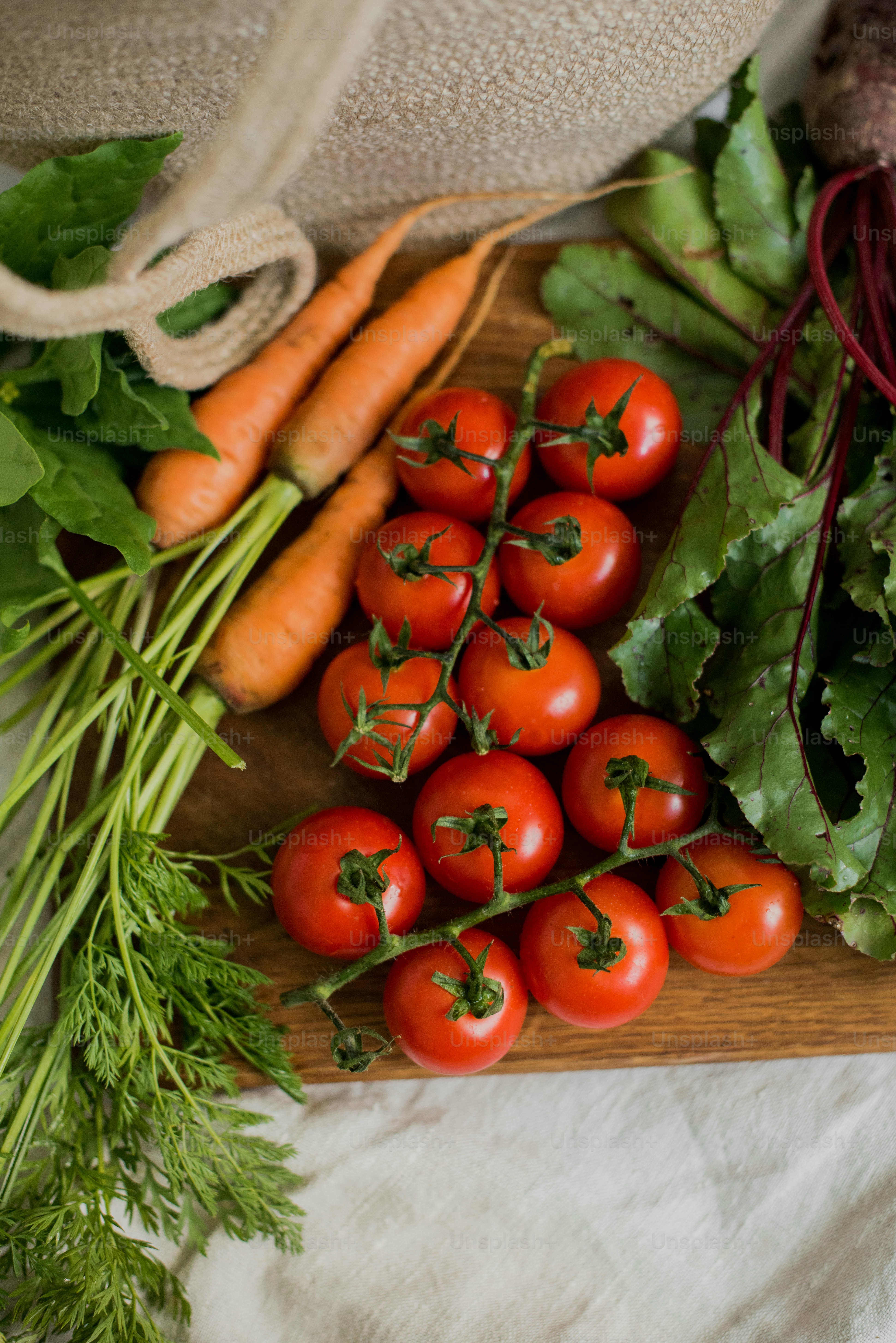 a wooden cutting board topped with lots of vegetables