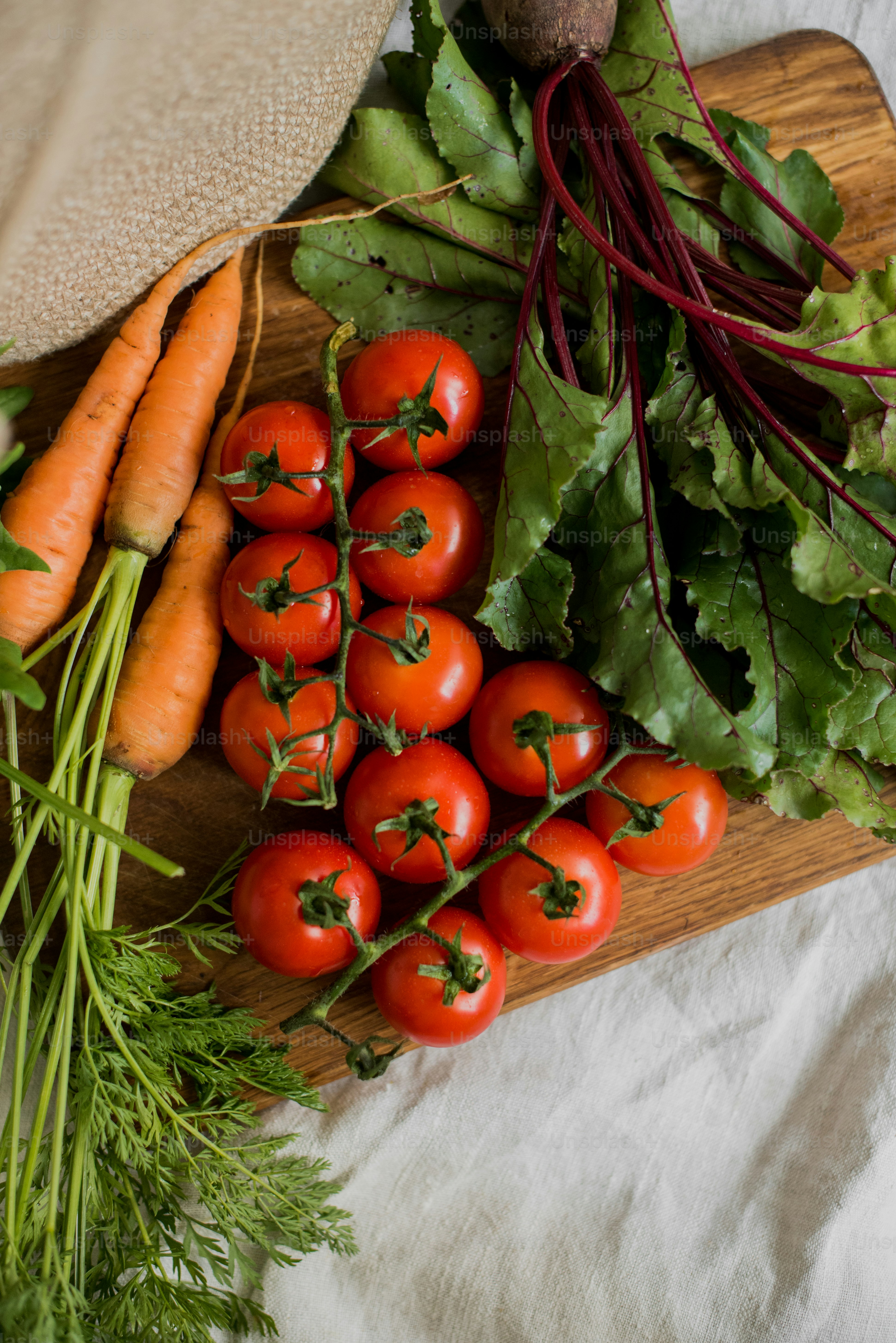a wooden cutting board topped with lots of vegetables