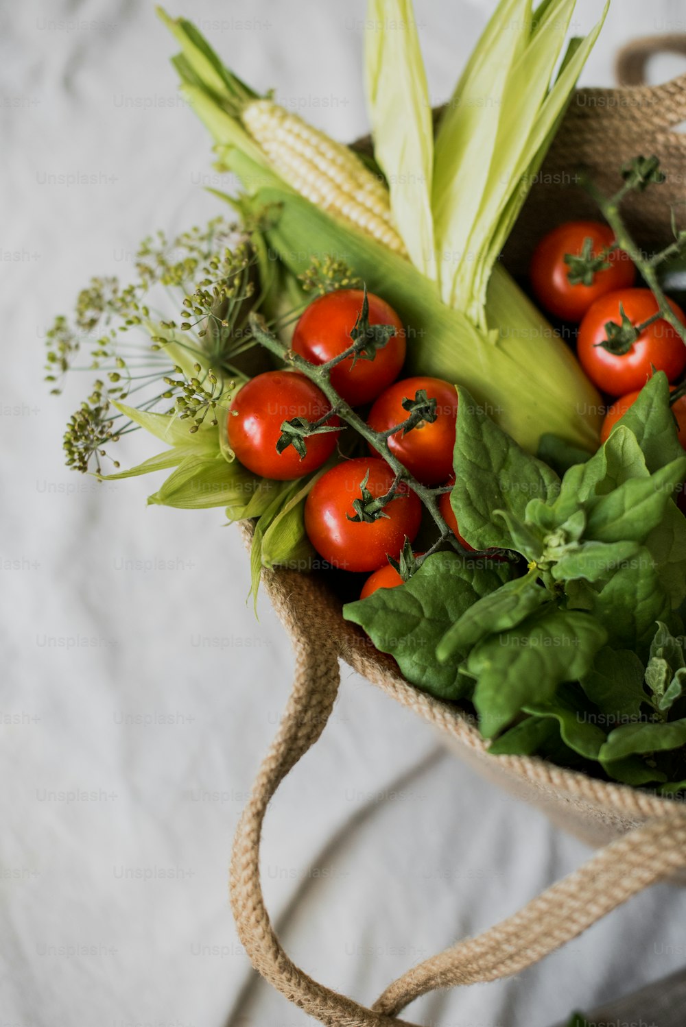 a bag filled with lots of vegetables on top of a table