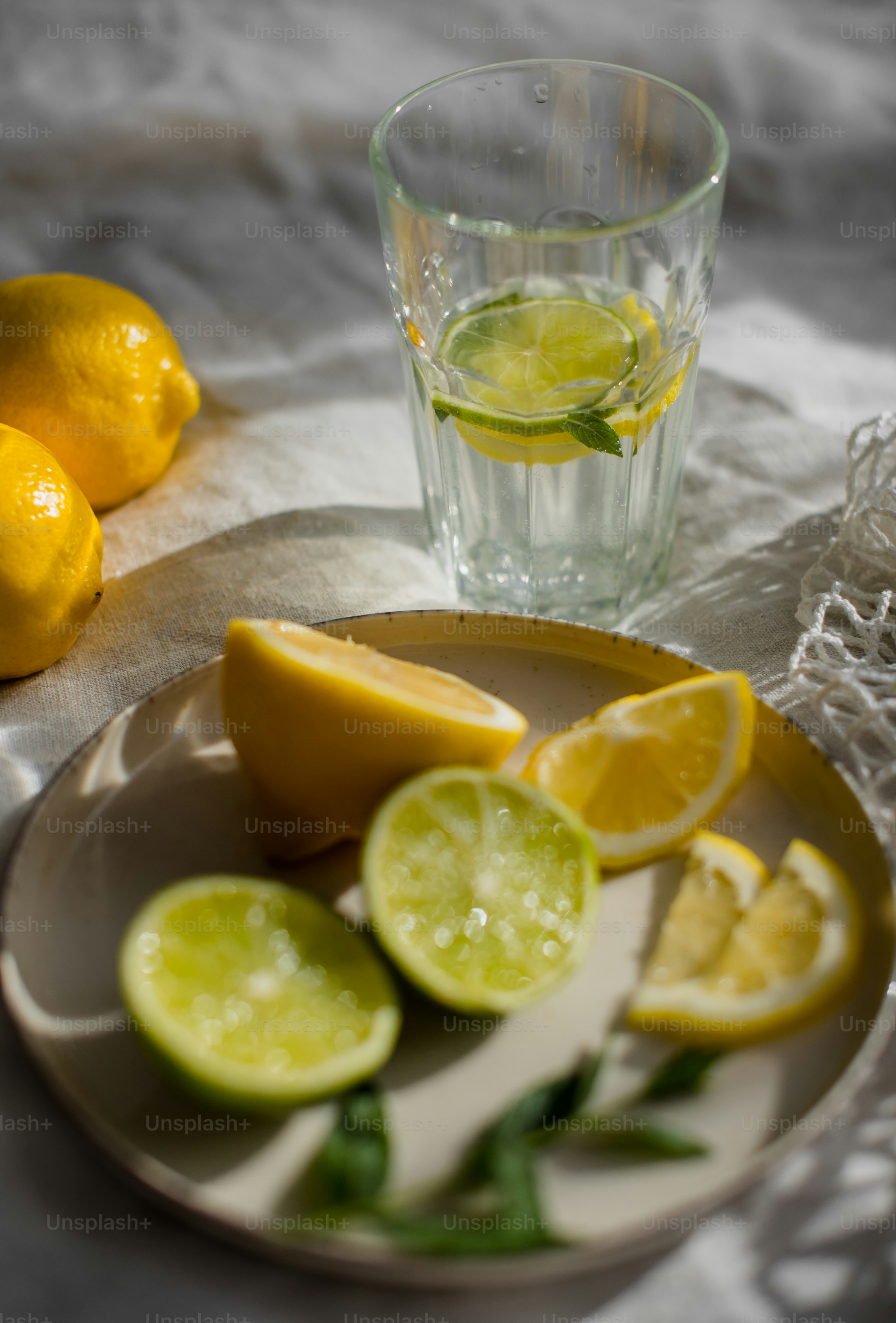 a plate of lemons and a glass of water