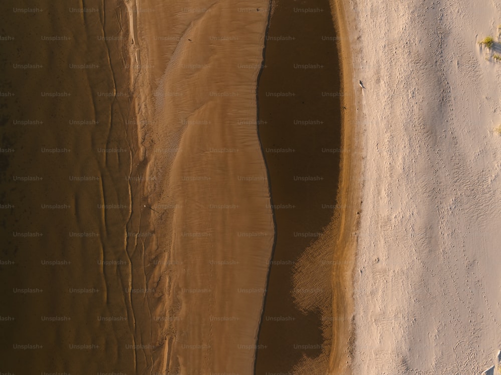 an aerial view of a sandy beach and ocean