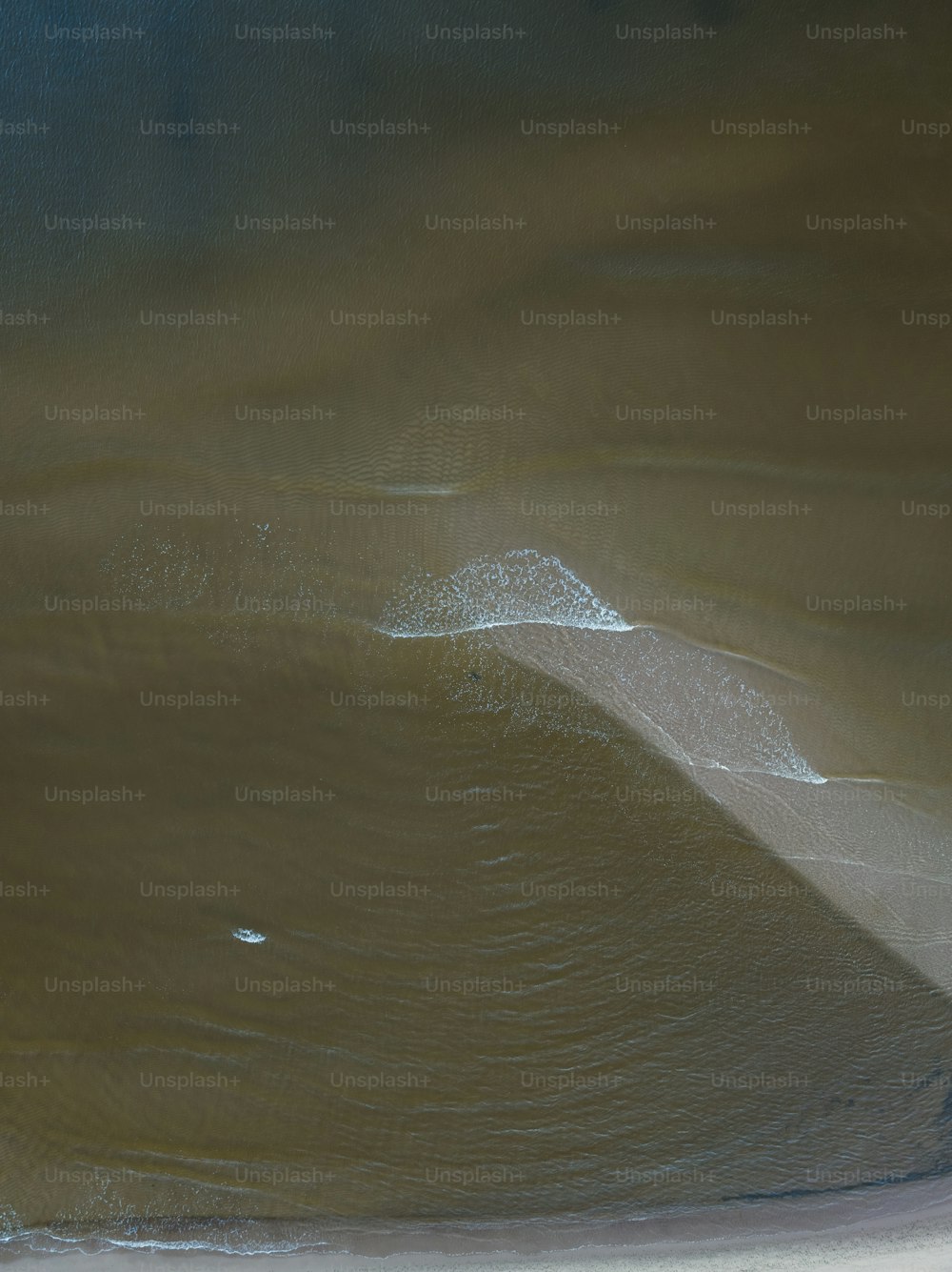 a man riding a surfboard on top of a wave