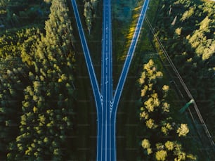 an aerial view of a road surrounded by trees