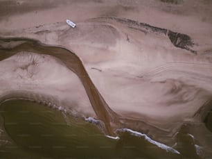 an aerial view of a boat on a body of water