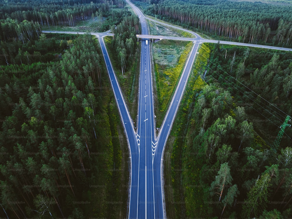 an aerial view of a road in the middle of a forest