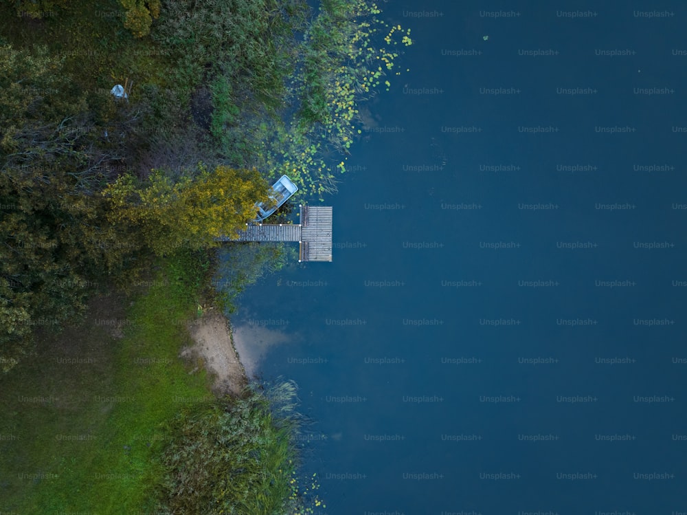 an aerial view of a dock on a lake