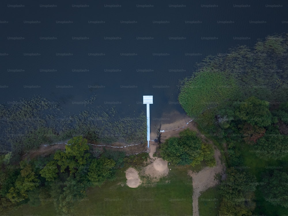 an aerial view of a tower in the middle of a lake
