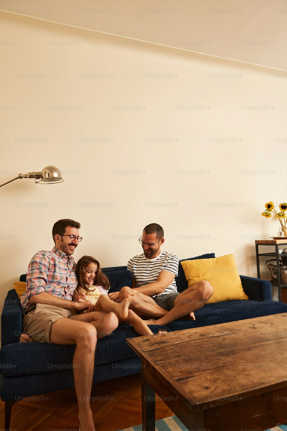a family sitting on a couch in a living room