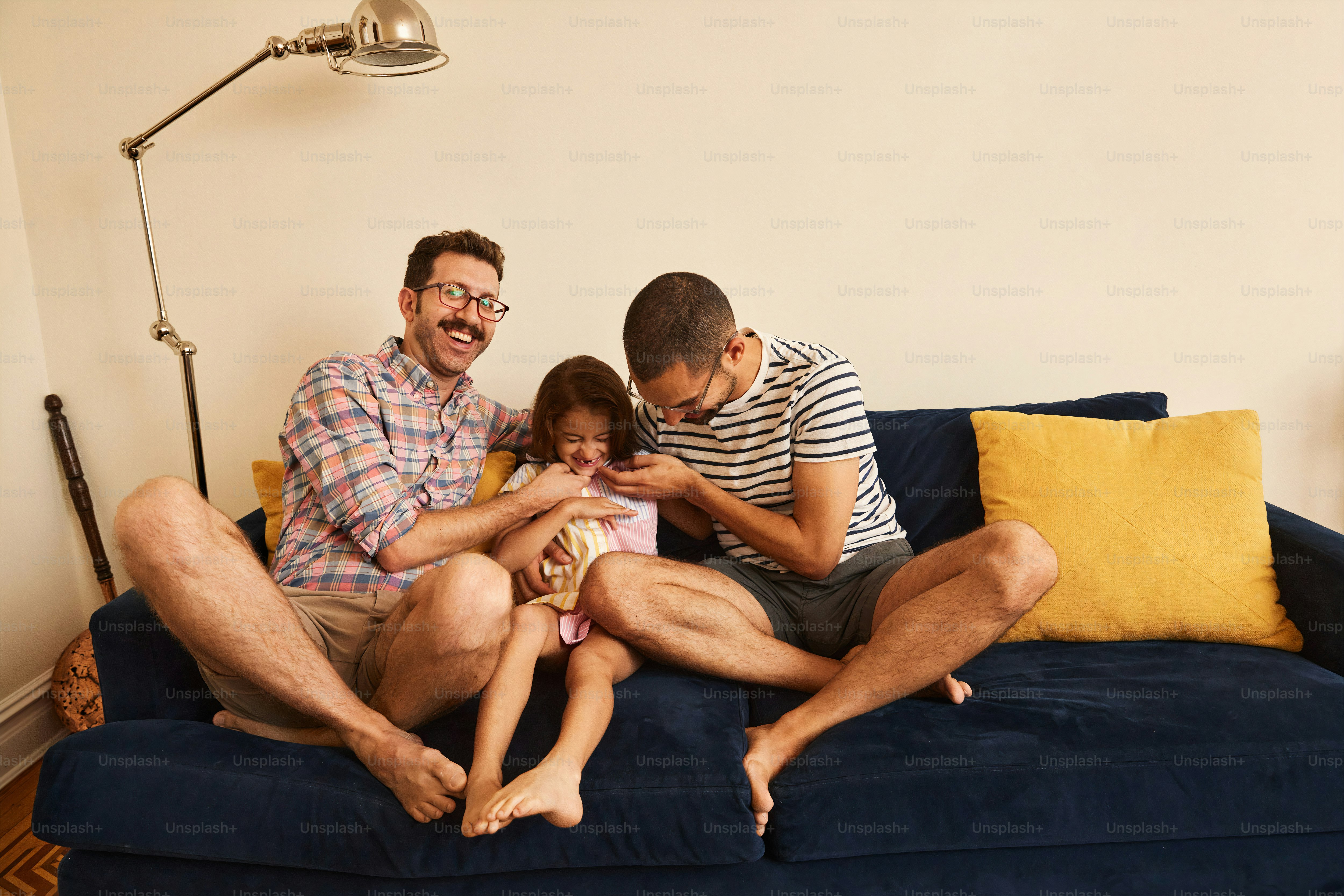 a man and two children sitting on a couch