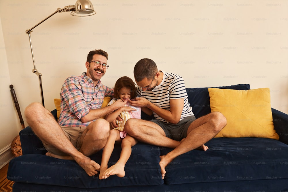 a man and two children sitting on a couch