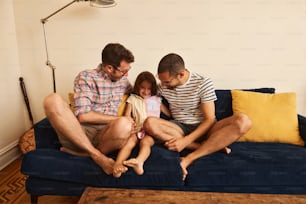 a family sitting on a blue couch together