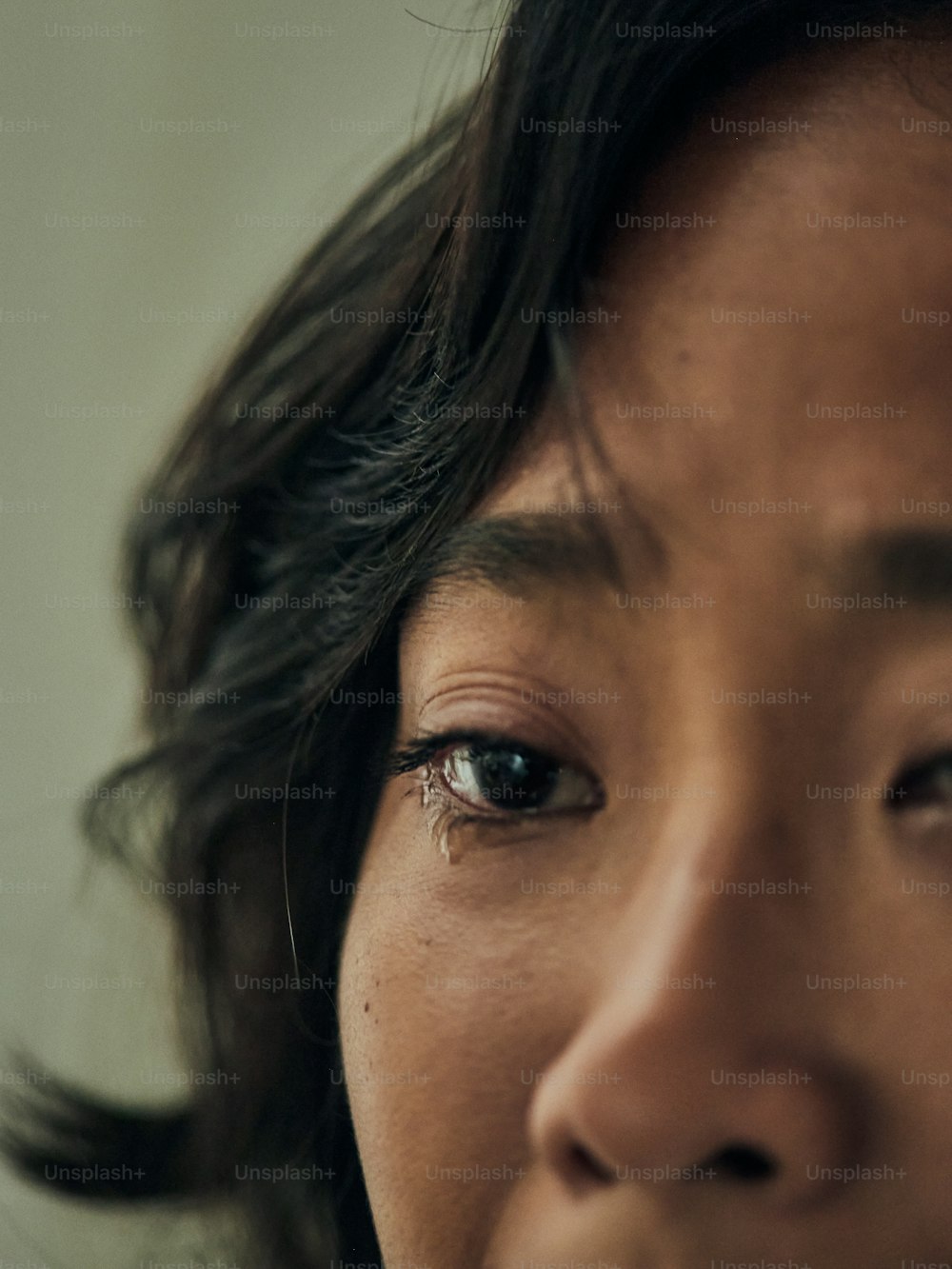 a close up of a woman's face with a concerned look on her face