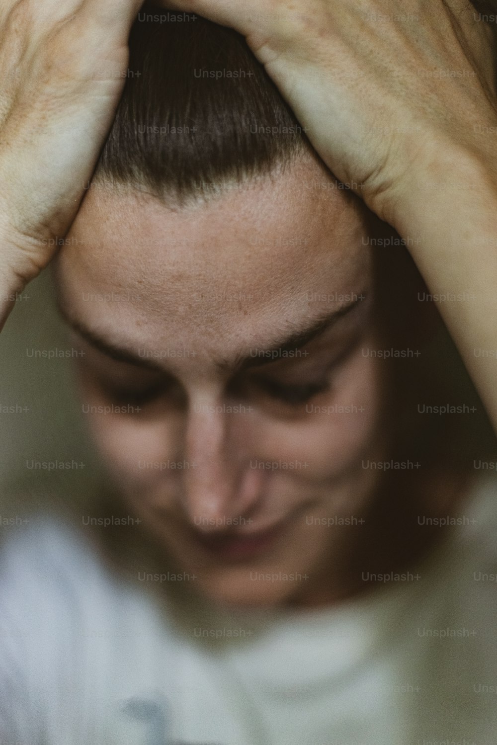 a woman holding her hands to her head