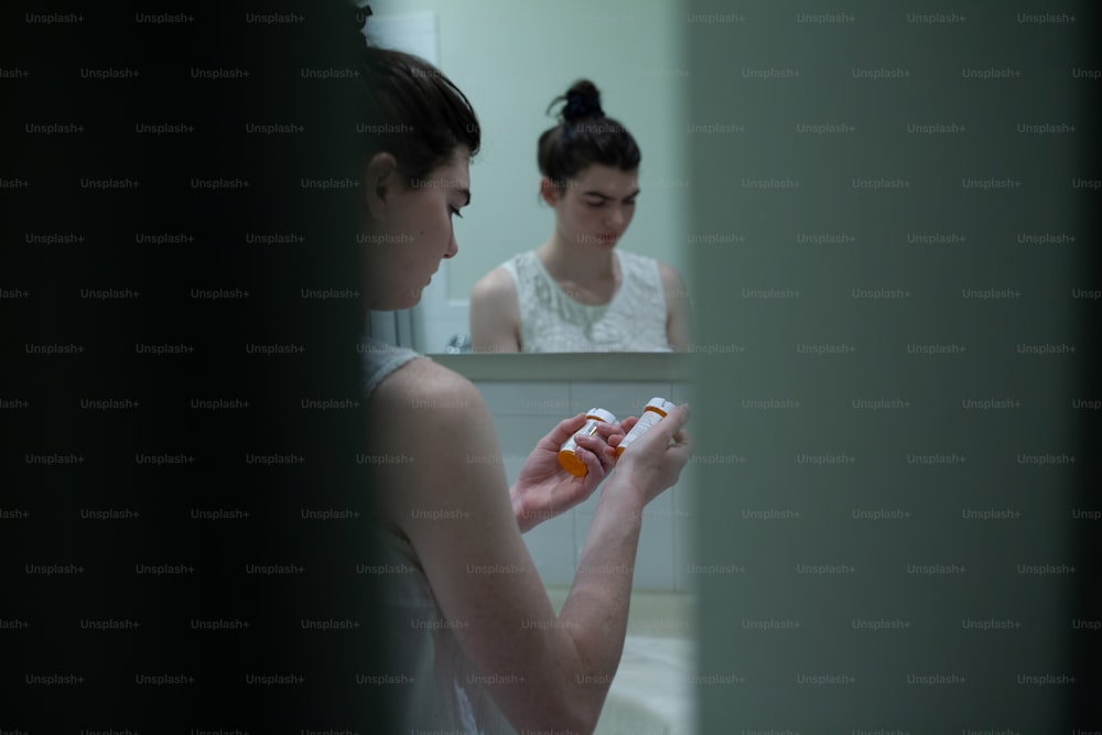 a woman brushing her teeth in front of a mirror