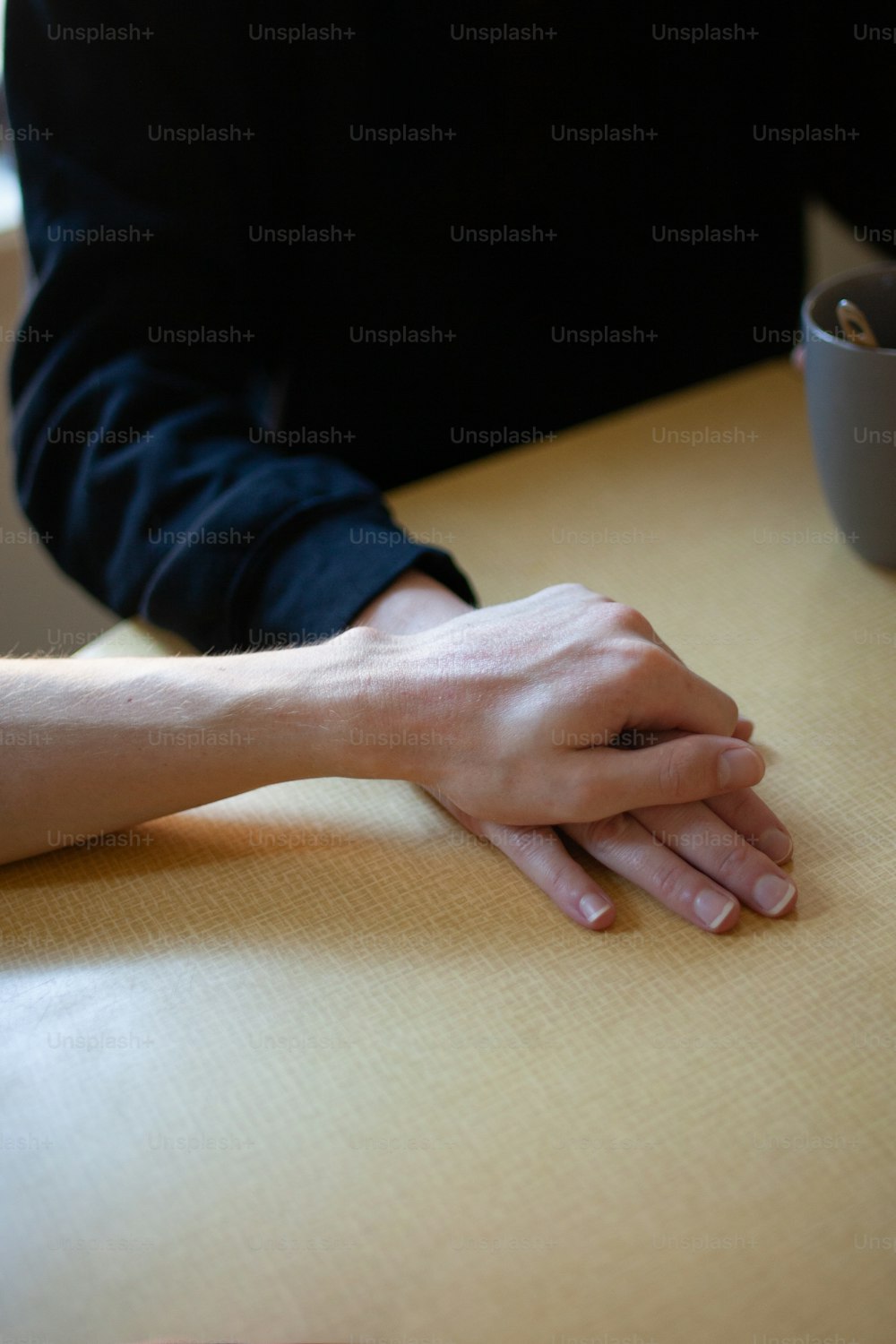 un gros plan des mains d’une personne sur une table