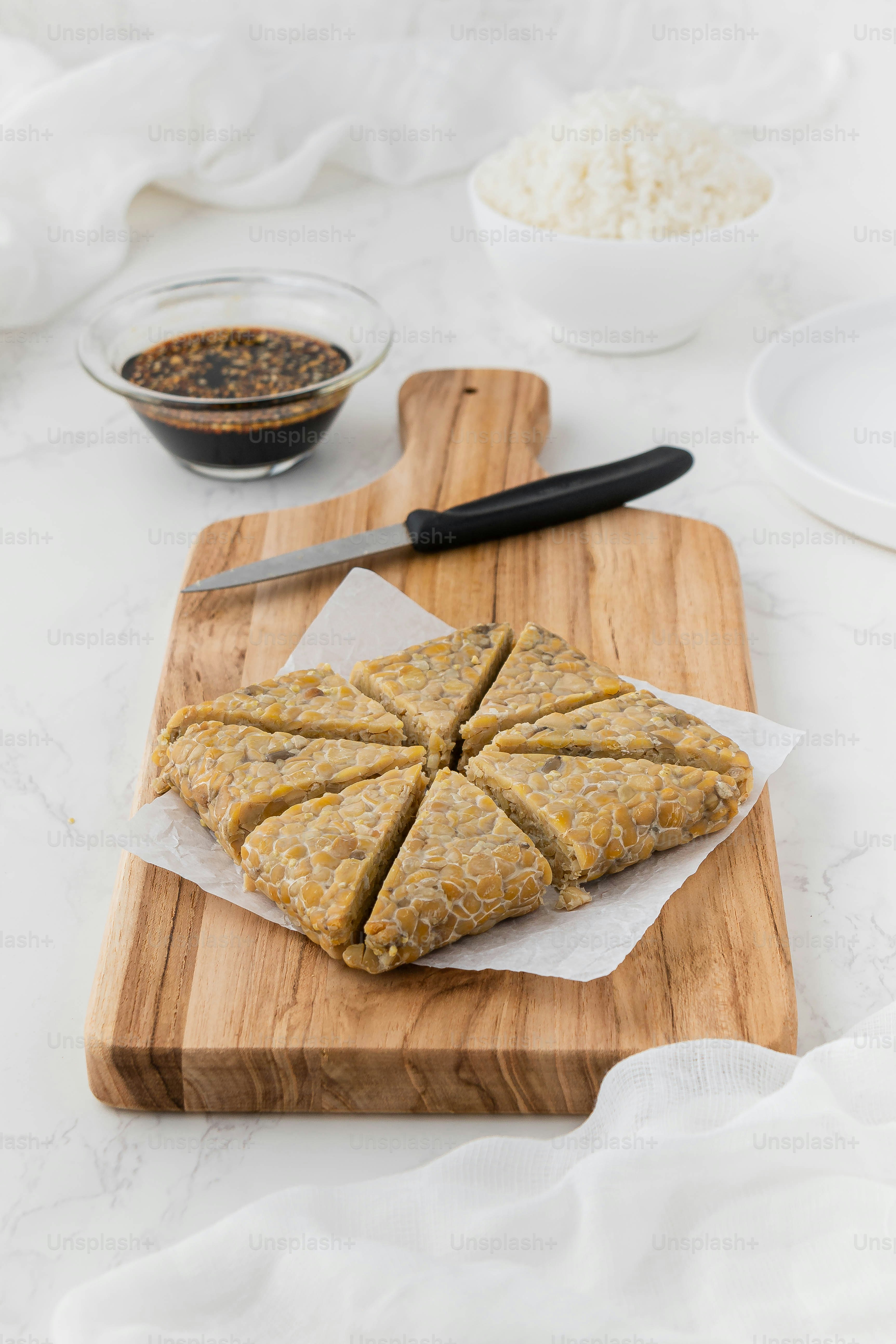 a wooden cutting board topped with sliced up food