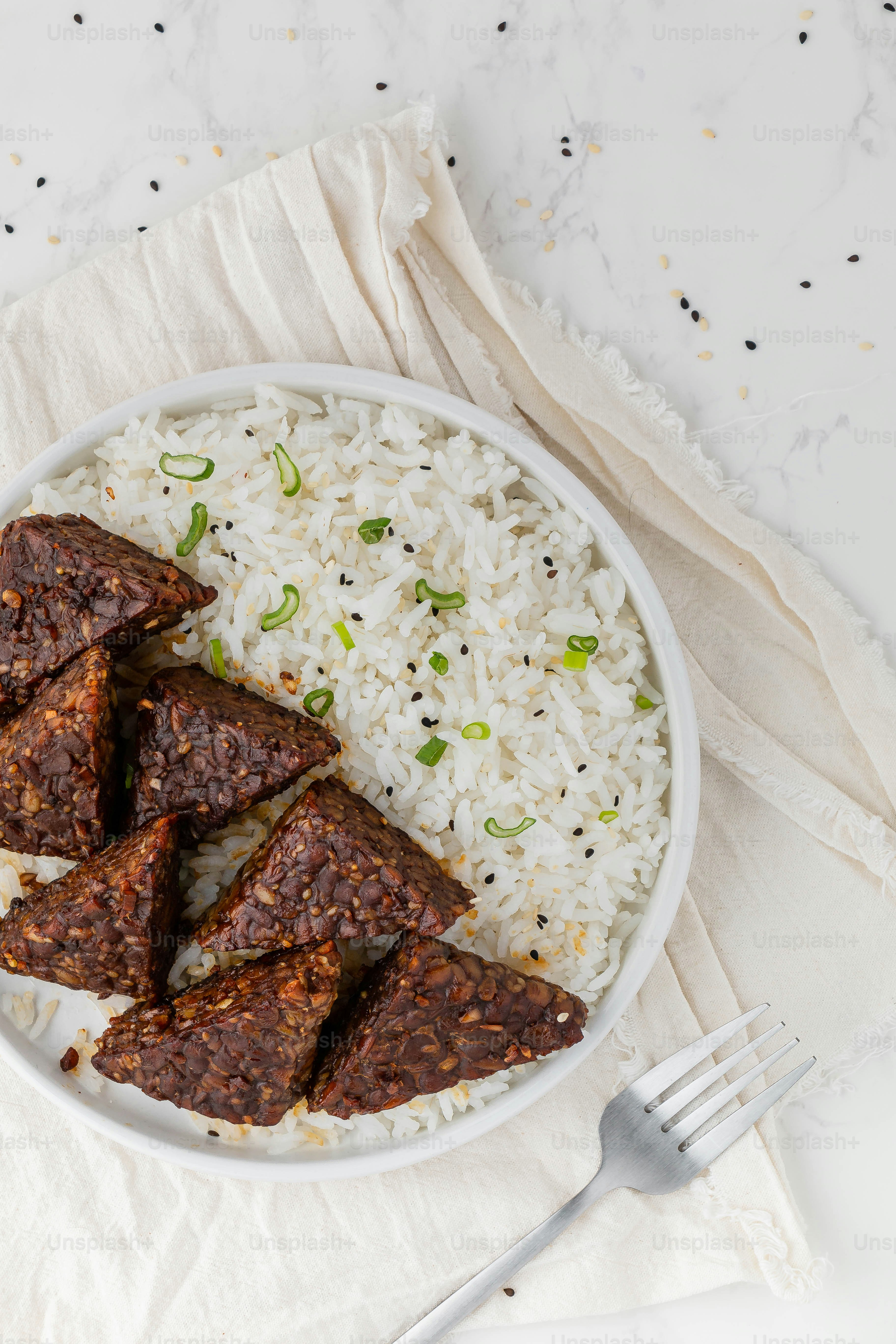 a white bowl filled with rice and meat