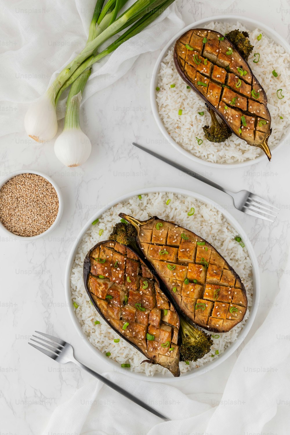 two plates of food on a white table