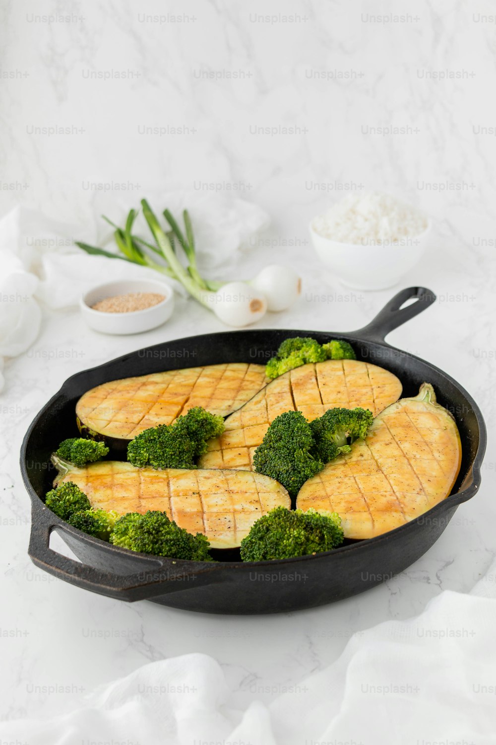 a pan filled with broccoli and sliced meat