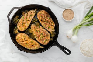 a skillet filled with chicken and broccoli