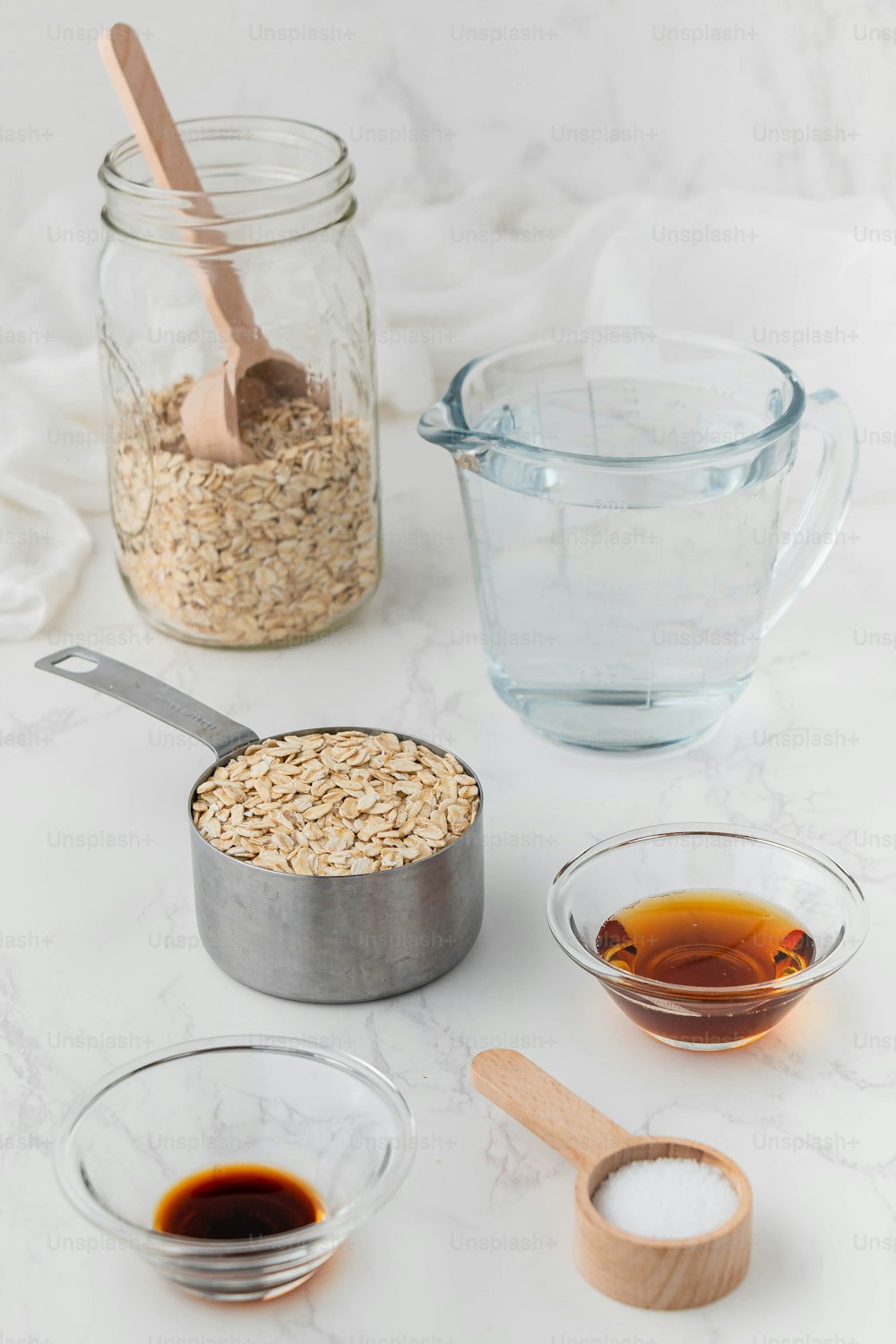 a table topped with bowls of food and a measuring cup