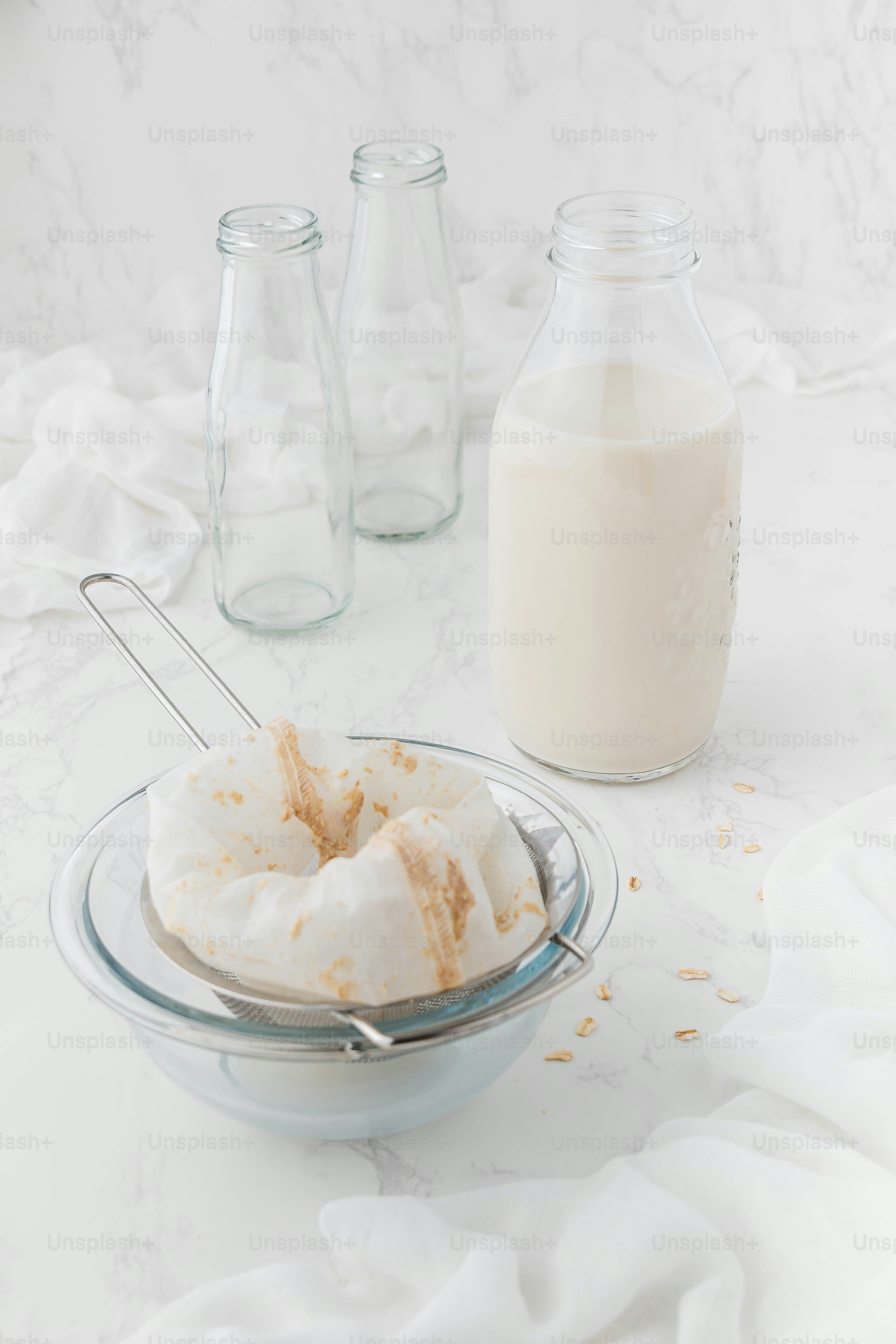a glass bowl filled with food next to a bottle of milk