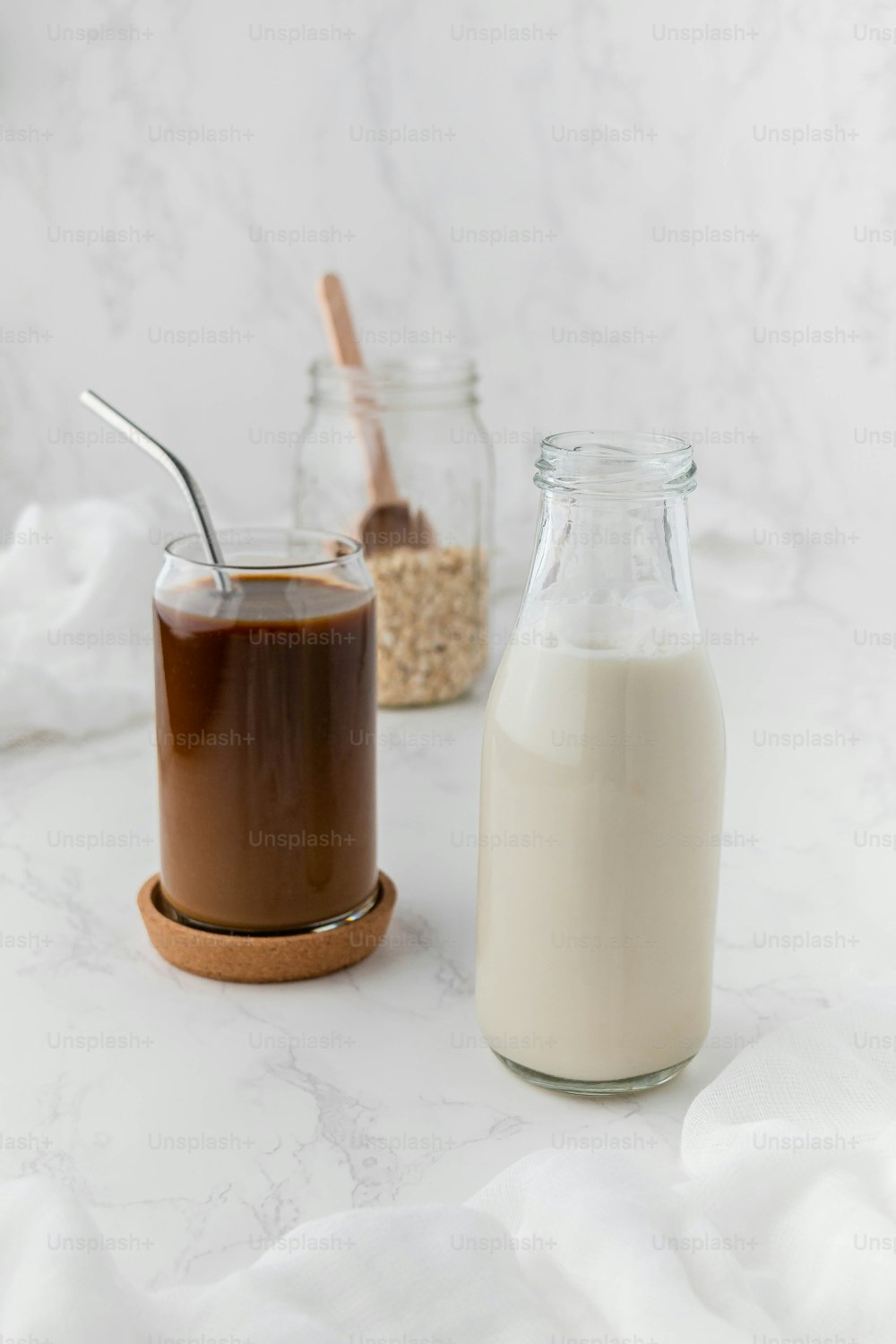 a bottle of milk next to a jar of chocolate pudding