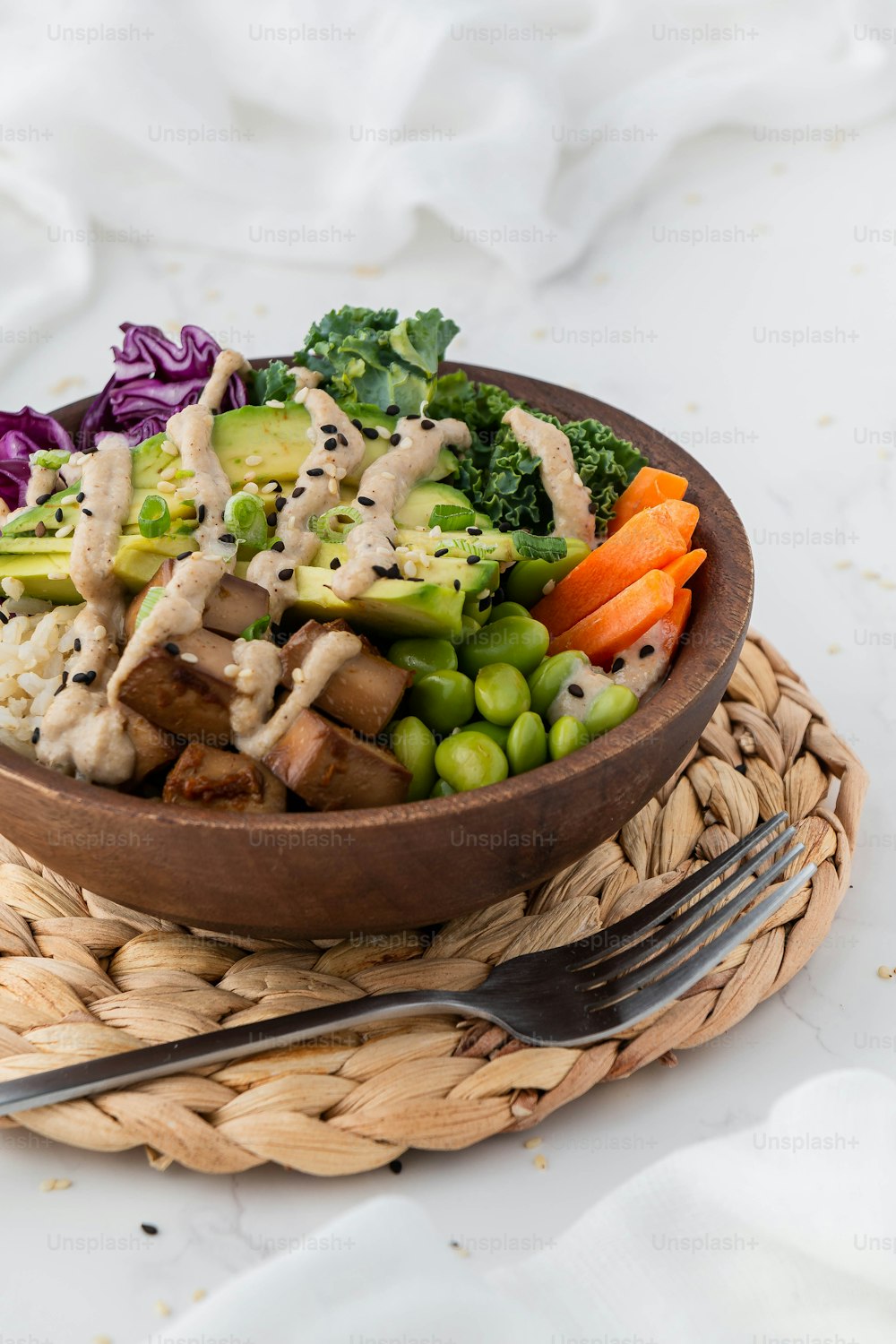 a wooden bowl filled with vegetables and meat