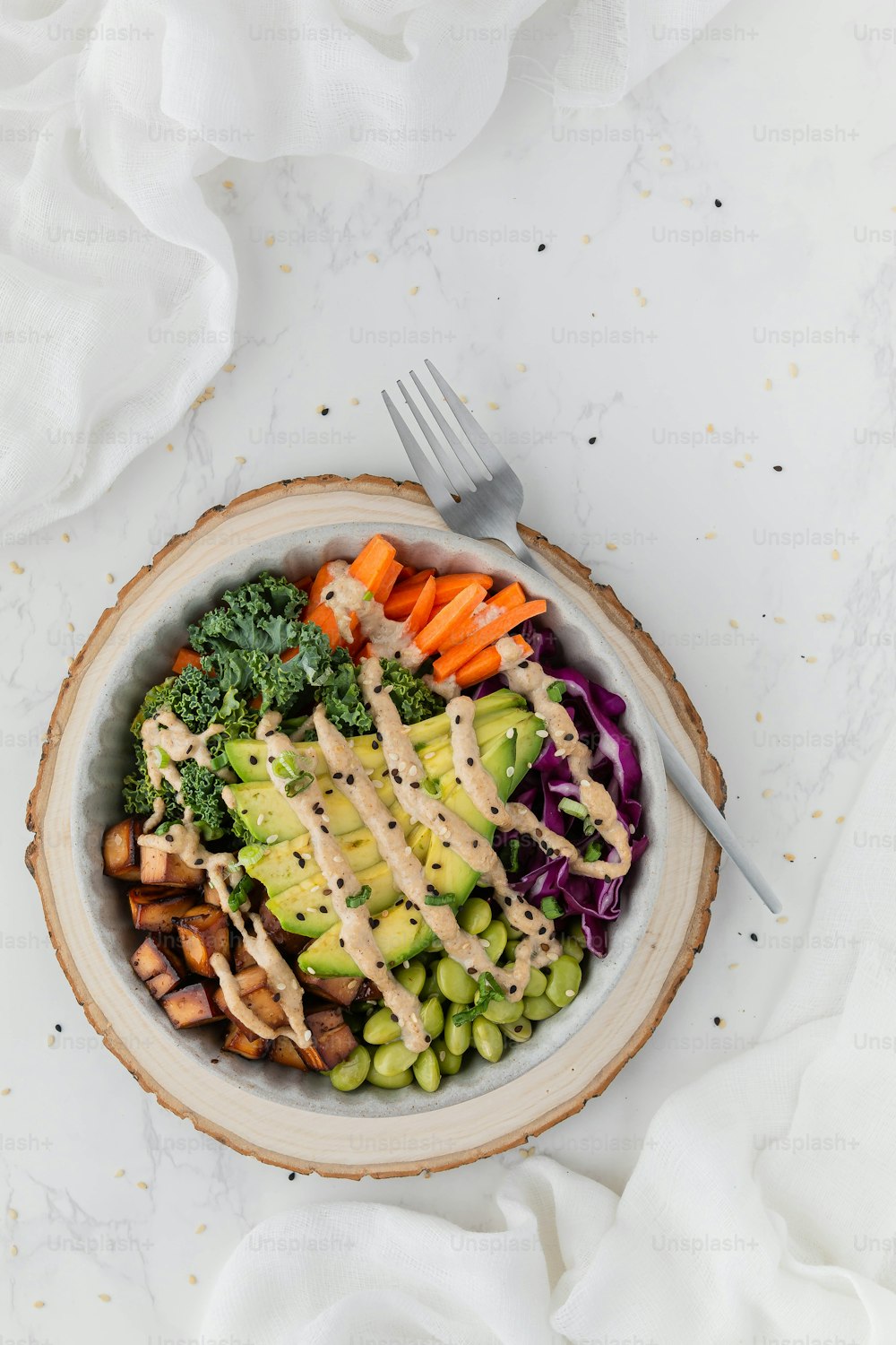 a white bowl filled with vegetables and dressing