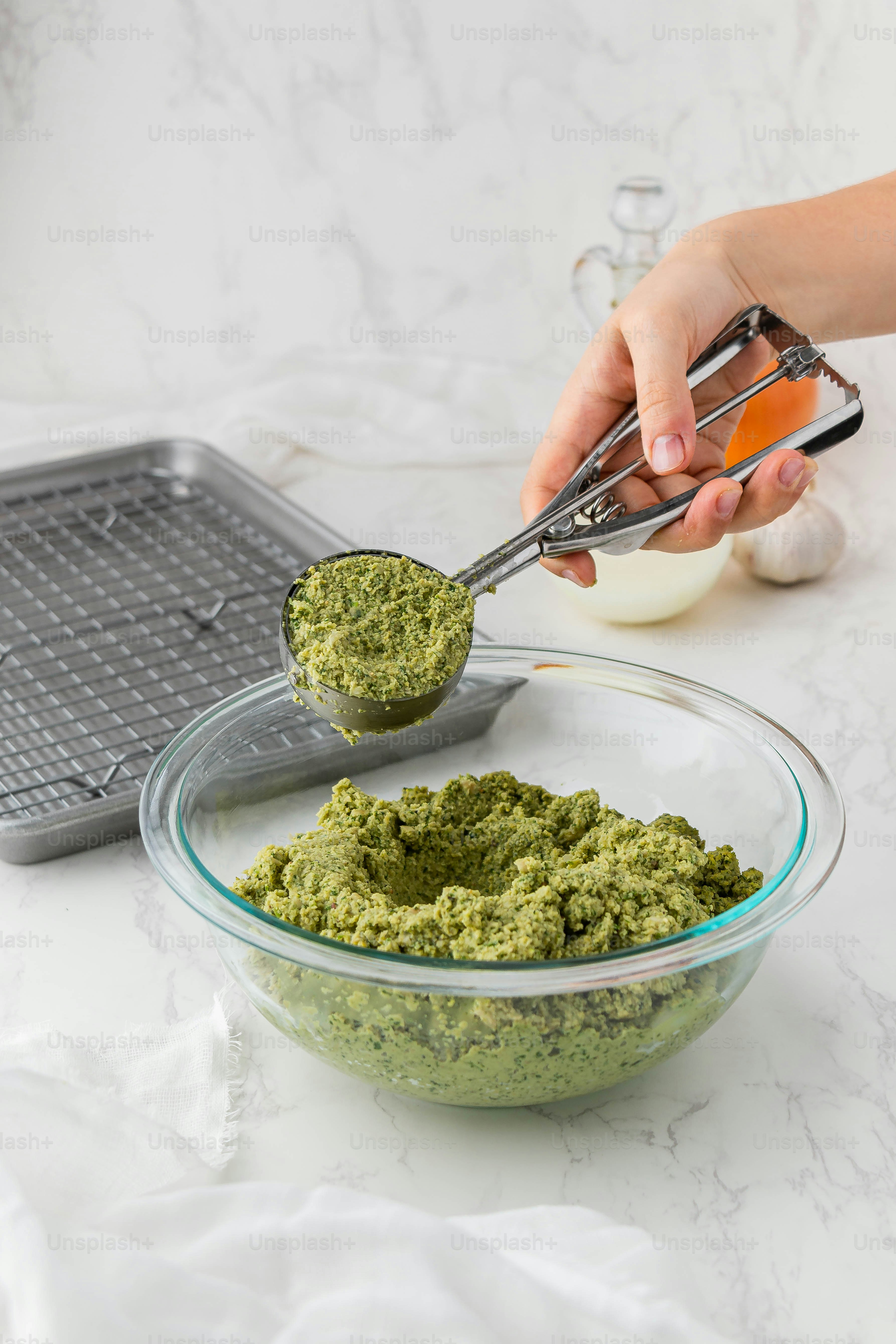 a person scooping pest from a glass bowl