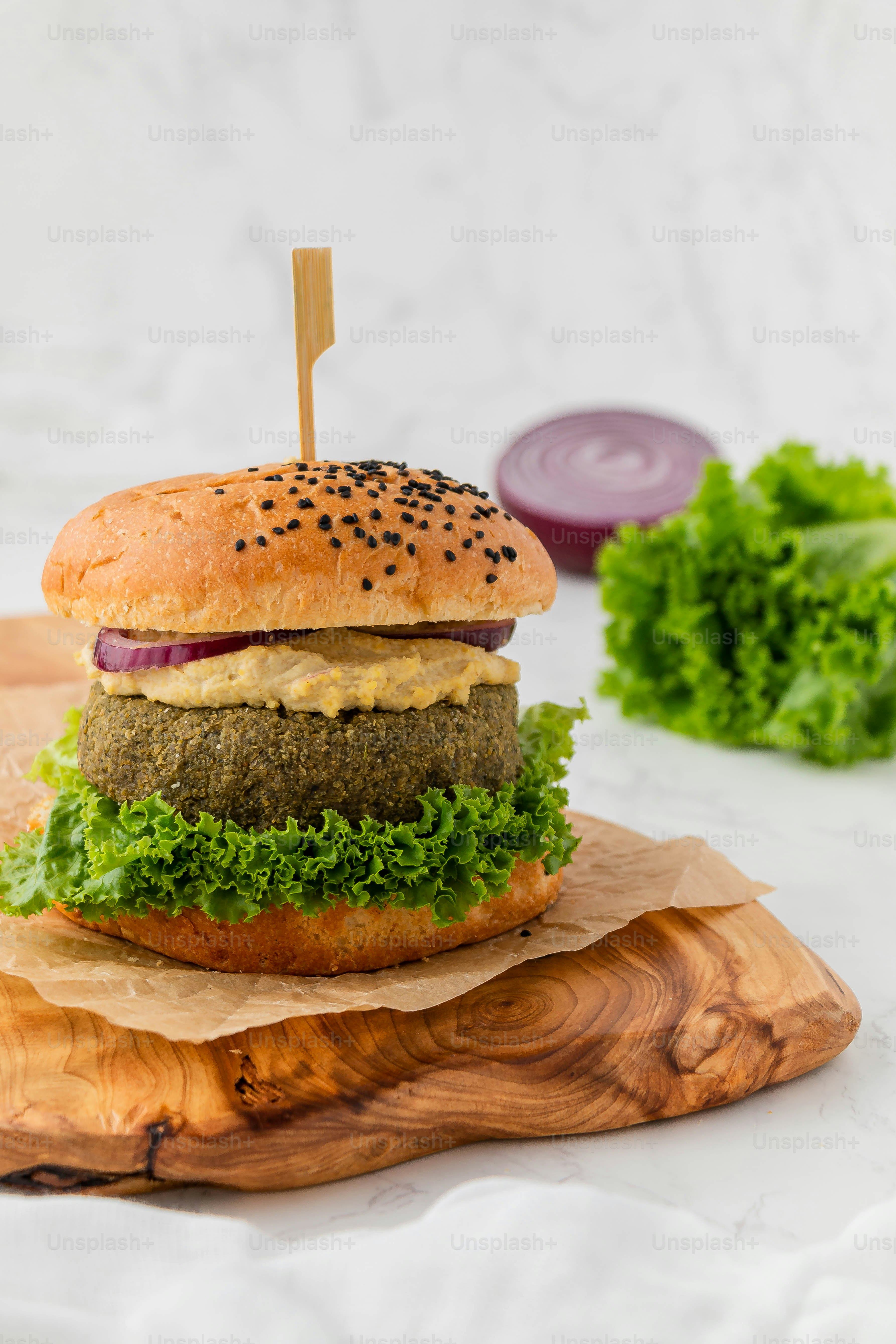 a hamburger sitting on top of a wooden cutting board