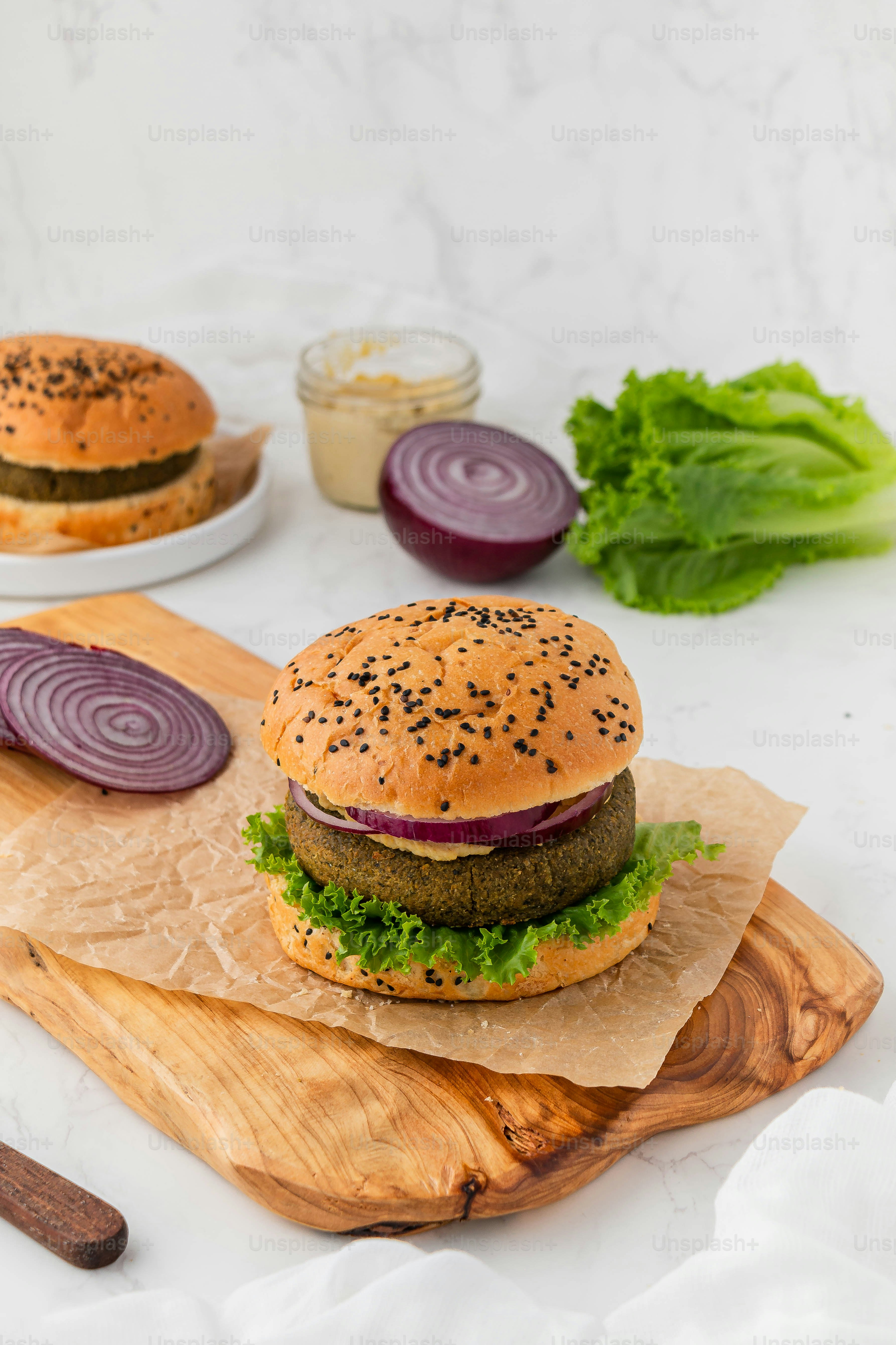a hamburger sitting on top of a wooden cutting board