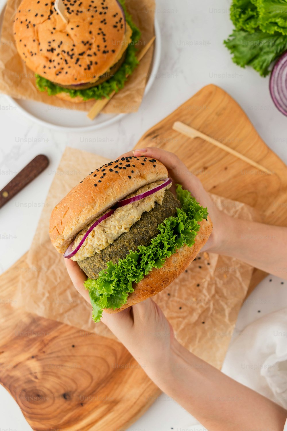 a person holding a sandwich in their hand