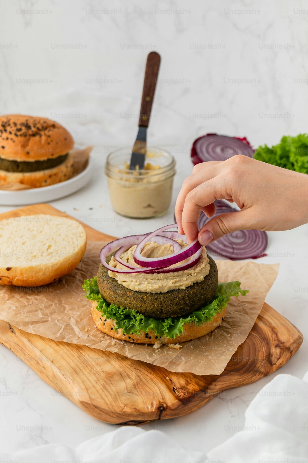 a person is making a sandwich on a cutting board