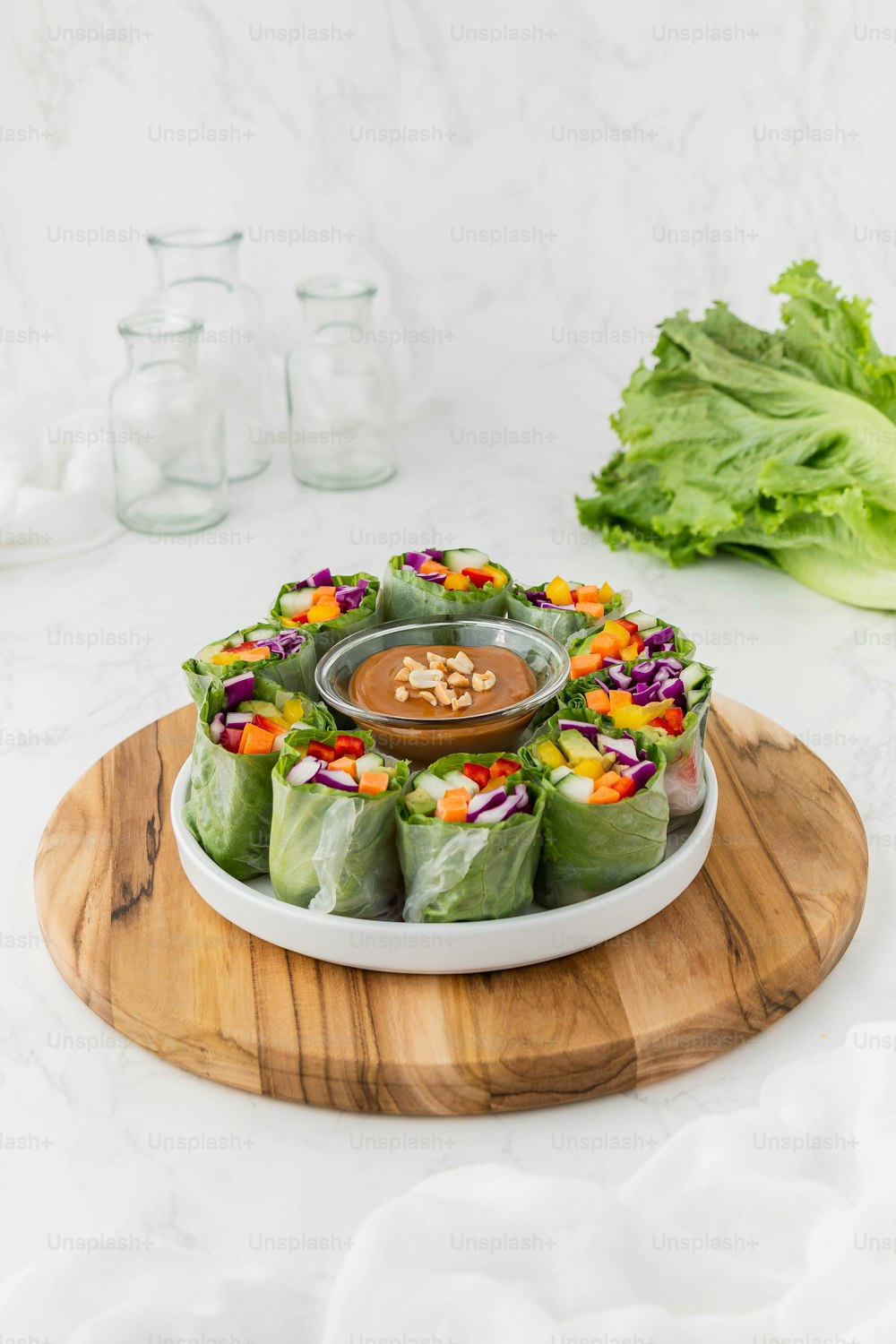 a plate of food with lettuce and a dipping sauce