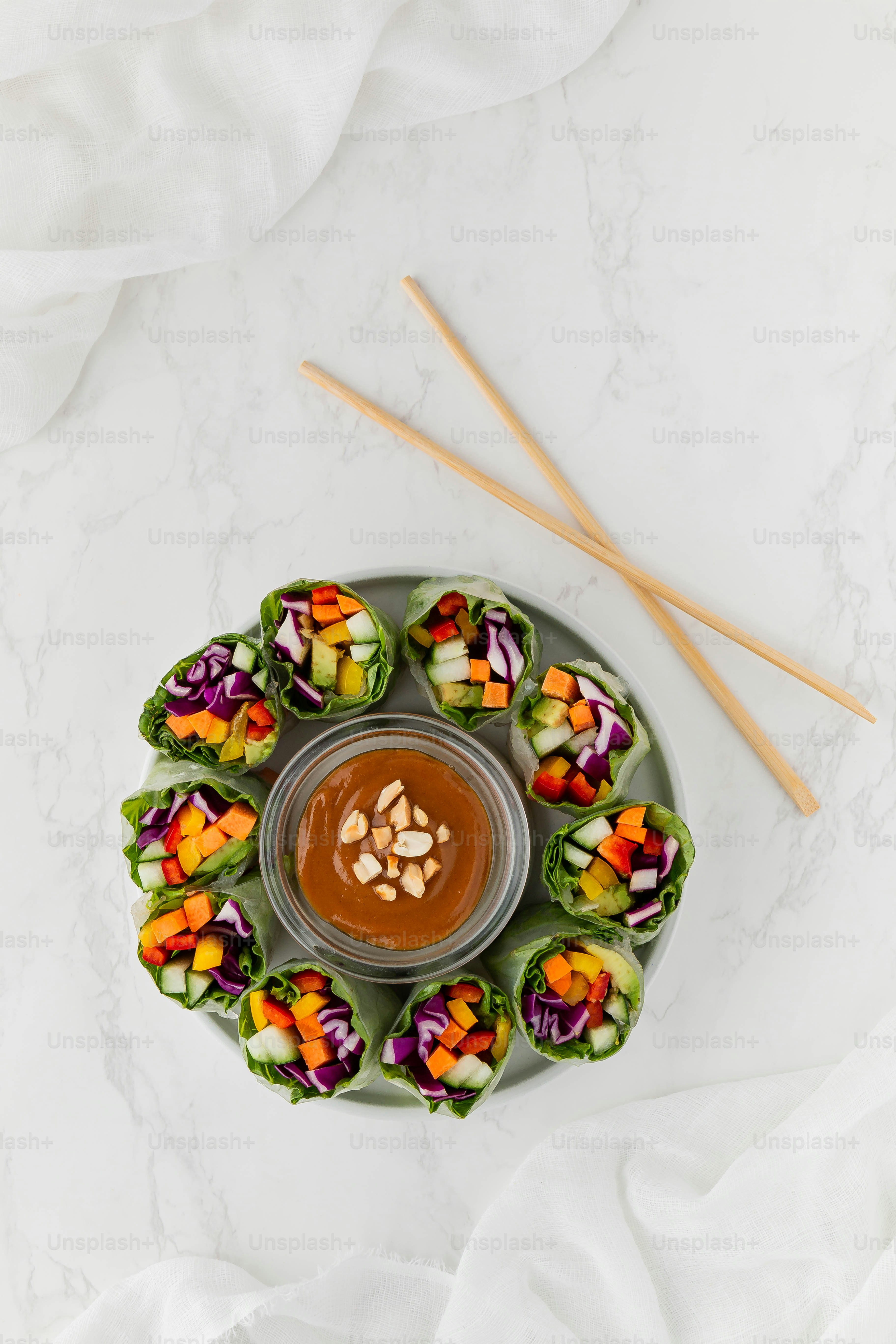 a plate of food with dipping sauce and chopsticks